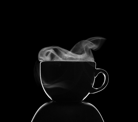Coffee cup with steam isolated on black background