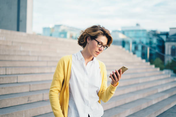 Caucasian woman using smartphone outdoors