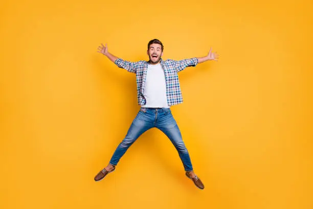 Photo of Full-legh portrait of of crazy and excited handsome man jumping