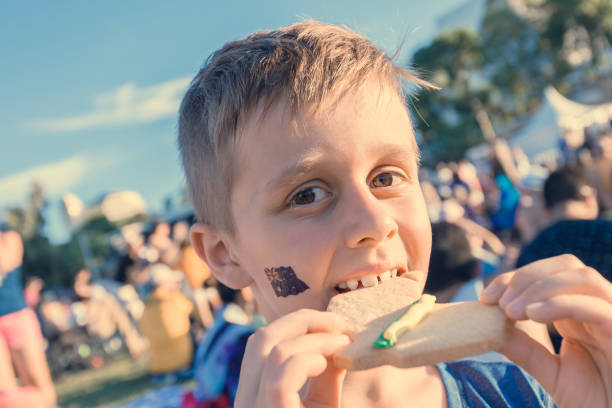 istock Cute Australian boy with flag tattoo on his face 1036116130