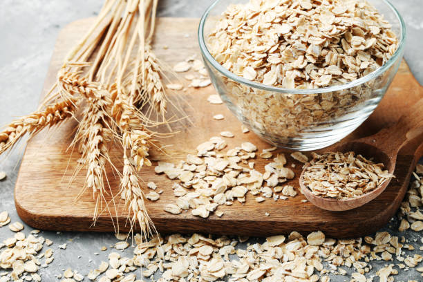 istock Oatmeal in bowl on brown cutting board 1036120522