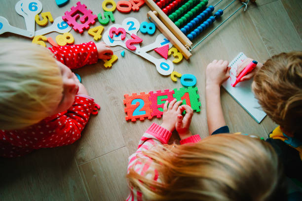 istock kids- boy and girls- learning numbers, abacus calculation 1036121374