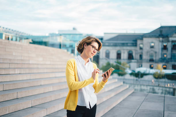 istock Caucasian woman using smartphone outdoors 1036121640