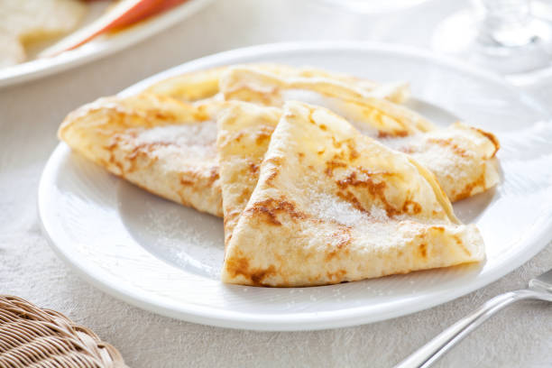 Bunch of homemade french crepes with sugar