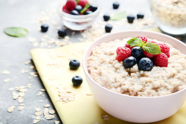 istock Oatmeal with berries in bowl on gray wooden table 1036125270