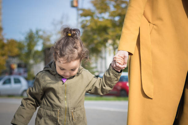 istock Mother and daughter holding hands. 1036125436