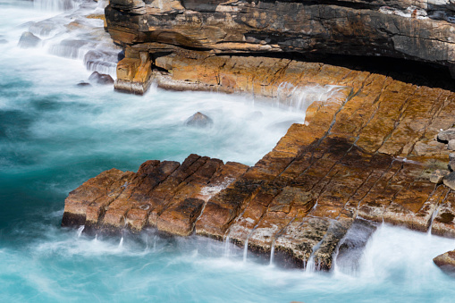 Waves crash against the cliffs on the seaward side of Watsons Bay in Sydney.