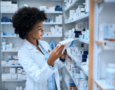 Shot of a young woman using a digital tablet to do inventory in a pharmacy