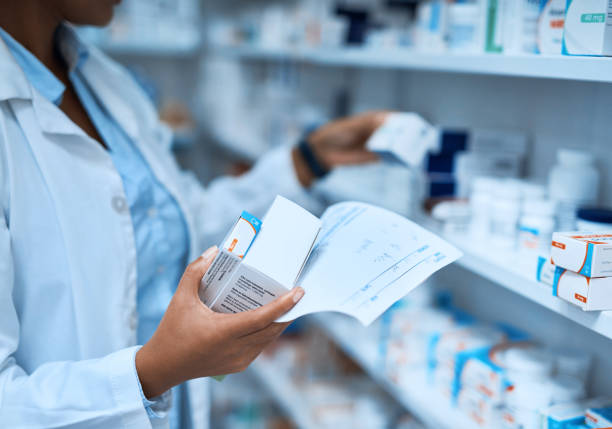 Your prescription is in expert hands Cropped shot of a pharmacist filling a prescription at a chemist chemist stock pictures, royalty-free photos & images