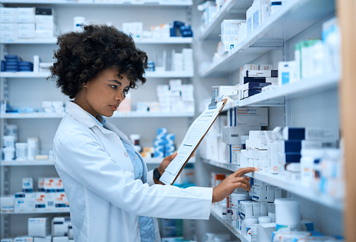 Shot of a young woman doing inventory in a pharmacy