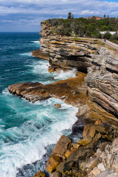 Waves crash against the cliffs on the seaward side of Watsons Bay in Sydney.