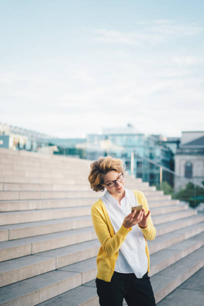 istock Caucasian woman using smartphone outdoors 1036136162