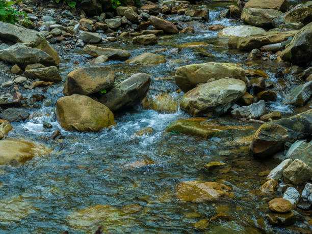 Mountain waterfall with blue, clear water. Summer background