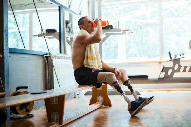 istock Disabled young man taking a break after training in the gym 1036143962