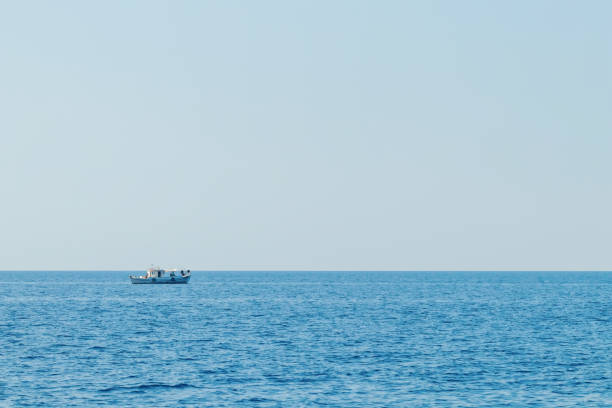 istock Fishing boat floating on the water, blue sea and sky 1036152134