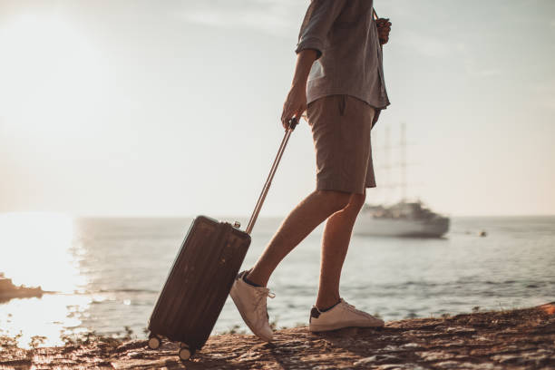 istock Tourist man with suitcase 1036165666