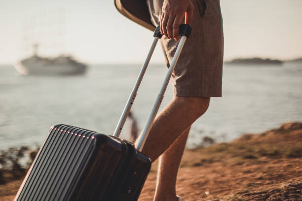 Walking by the sea with luggage