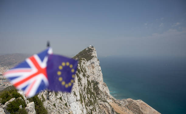 The Union Jack and the Flag of The European Union with The Rock of Gibraltar in the background, indicating the dispute over its sovereignty and the effects of Brexit with plenty of copyspace The Union Jack and the Flag of The European Union with The Rock of Gibraltar in the background, indicating the dispute over its sovereignty and the effects of Brexit with plenty of copyspace gibraltar photos stock pictures, royalty-free photos & images