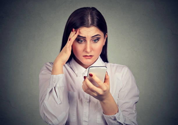 istock Upset shocked woman looking at mobile phone. 1036169568