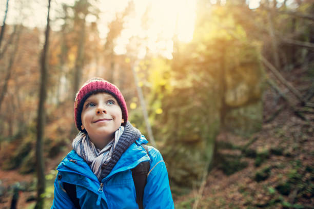 istock Little boy hiking in autumn forest 1036173736