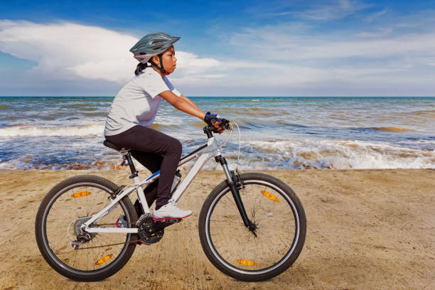 istock Girl cycling at beach on daylight 1036174620