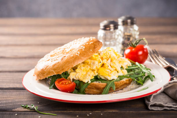 istock Freshly baked bagel filled with scrambled eggs 1036177618