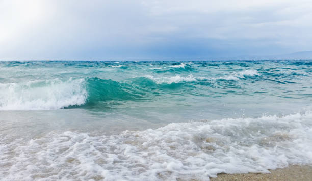 istock Strong waves crash over the beach Beautiful seascape. 1036183120