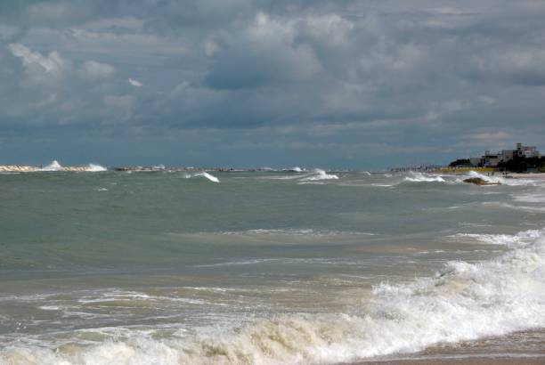 istock windy day at sea with big waves against rocks 1036183346