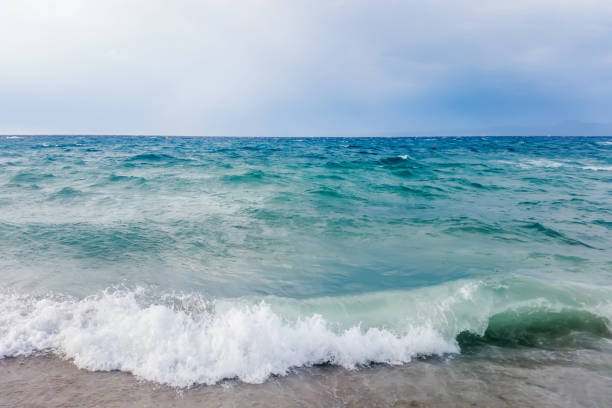 istock Strong waves crash over the beach Beautiful seascape. 1036186386