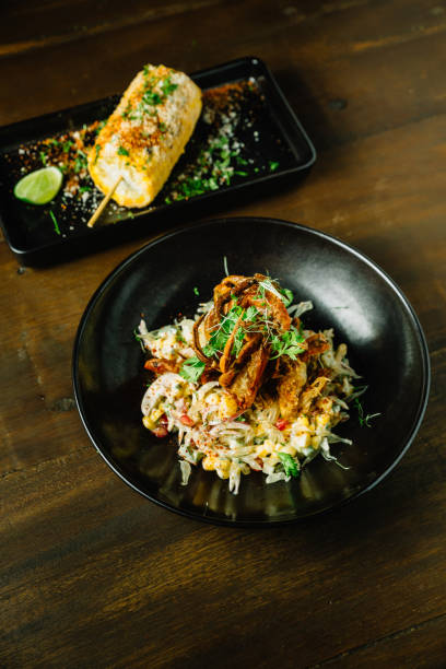 istock Mexican style pomelo salad topping with deep fried soft shell crab in black plate. 1036186884