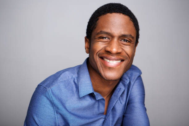 istock smiling african businessman against gray background 1036189902