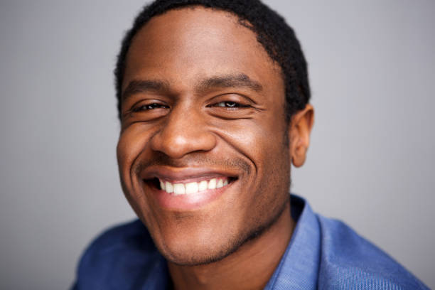 istock Close up happy african man smiling against gray background 1036189928