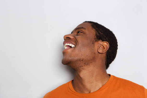 istock Close up african man laughing against white background 1036190016