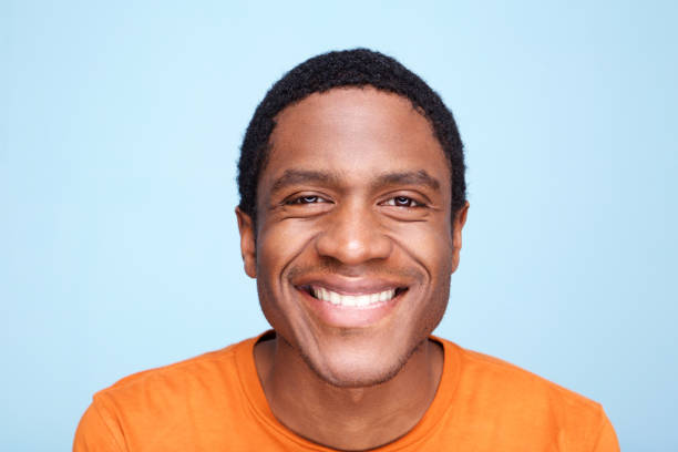 istock Close up african american man smiling against blue background 1036190096