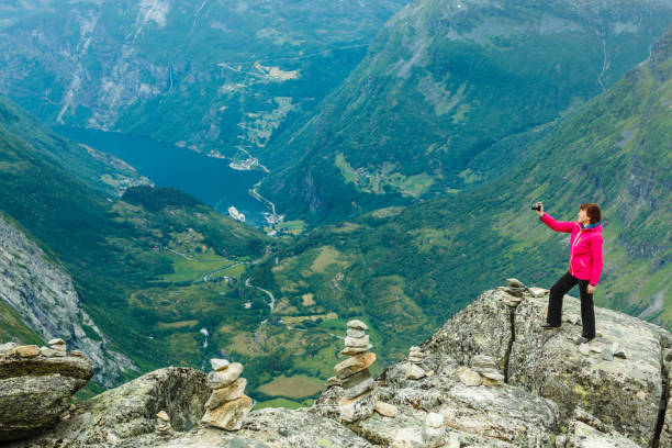 istock Tourist taking photo from Dalsnibba viewpoint Norway 1036190120