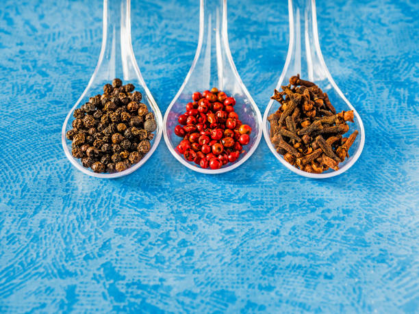 istock Three spoons with spicy ingredients on blue textured background 1036190150