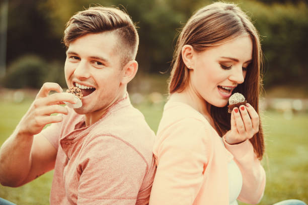 istock Lovely couple eating cupcakes. 1036190454