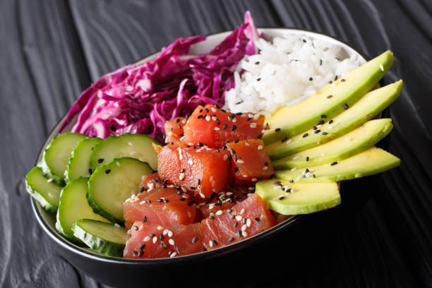 istock Marinated tuna poke bowl with rice, fresh cucumbers, red cabbage and avocado close-up. horizontal 1036190644
