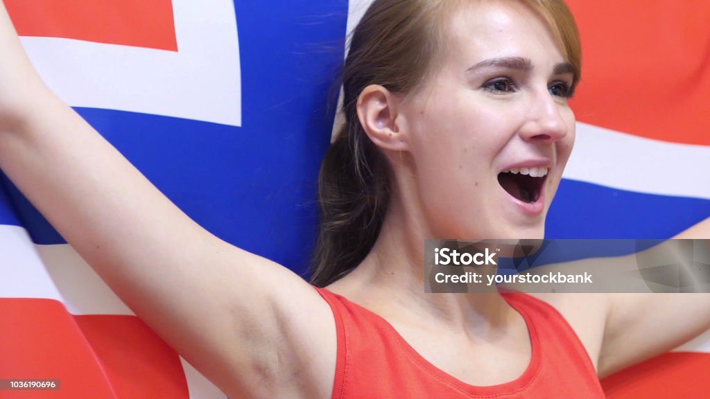 Norwegian Young Woman Celebrates holding the Flag of Norway in Slow Motion Athlete Stock Photo