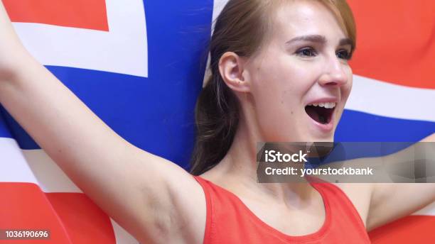 Norwegian Young Woman Celebrates Holding The Flag Of Norway In Slow Motion Stock Photo - Download Image Now