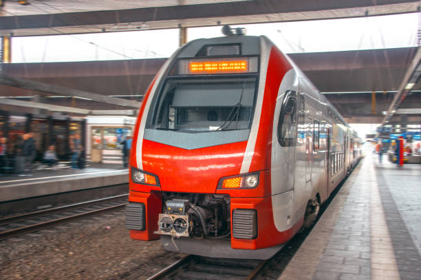 istock Red passenger train inside a railroad station 1036195246