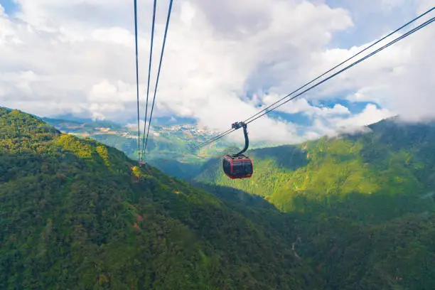 Photo of Cable car In the middle of the valley, fog in cloud background of country in Fansipan mountain SAPA VIERNAM.