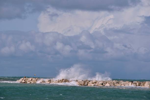 istock windy day at sea with big waves against rocks 1036208972