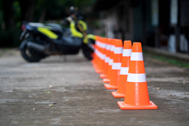 Traffic cone on road and blurred motorcycle