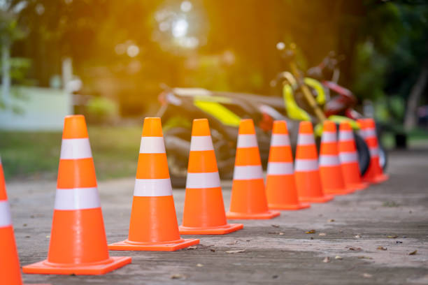 Traffic cone on road and blurred motorcycle stock photo
