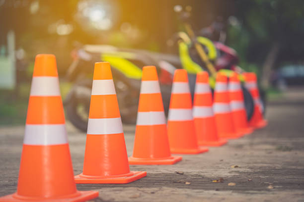 istock Traffic cone on road and blurred motorcycle 1036215950