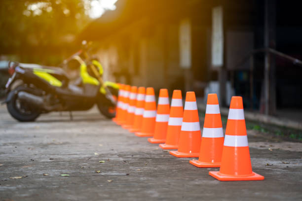 istock Traffic cone on road and blurred motorcycle 1036215958