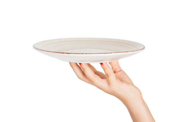 istock One white kitchen plate on human hand. perspective view, isolated on white background 1036220520