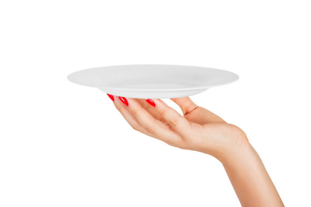 istock Blank empty round plate in female hand. perspective view, isolated on white background 1036220546