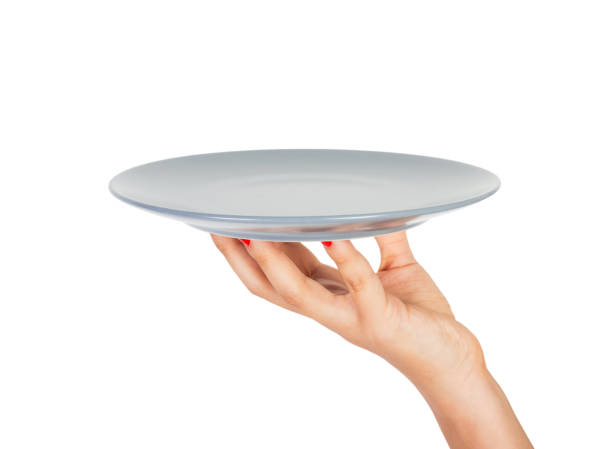 istock Blank empty round gray matte plate in female hand. perspective view, isolated on white background 1036220582